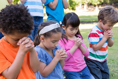Children Praying Outdoors